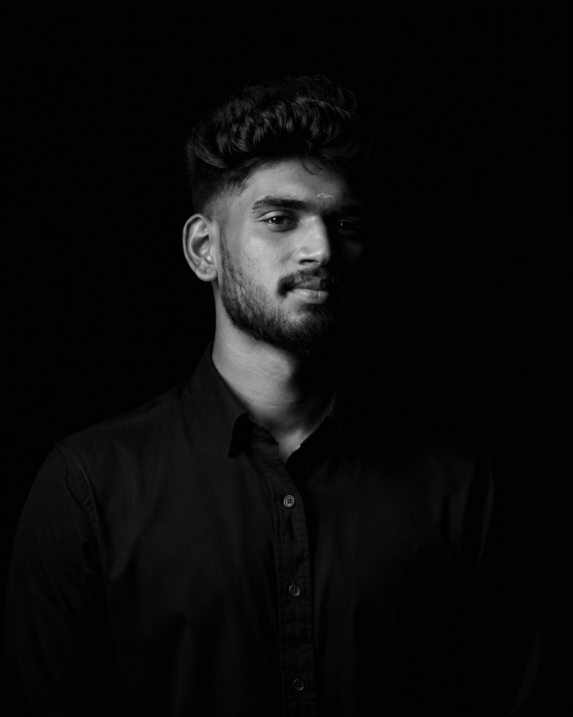 Harikrishna M K standing confidently with folded arms in a black sweatshirt, the best digital marketing expert in Palakkad, specializing in SEO, website design, graphic design, branding, video editing, and digital marketing.