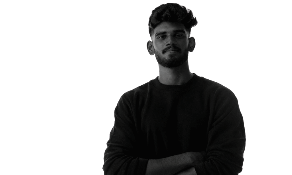 Harikrishna M K standing confidently with folded arms in a black sweatshirt, the best digital marketing expert in Palakkad, specializing in SEO, website design, graphic design, branding, video editing, and digital marketing.
